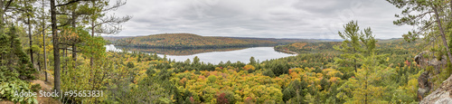 Panorama Looking Out Over a Lake Surrounded by Forest in Autumn