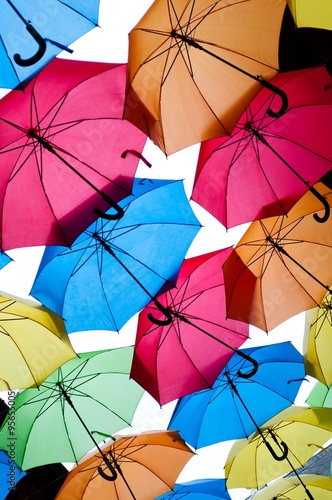 Many colorful umbrellas against the sky in city settings. Kosice, Slovakia. Color background