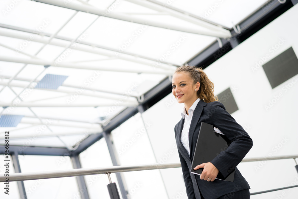 businesswoman talking on a mobile phone at the office businesswoman talking on a mobile phone at the office