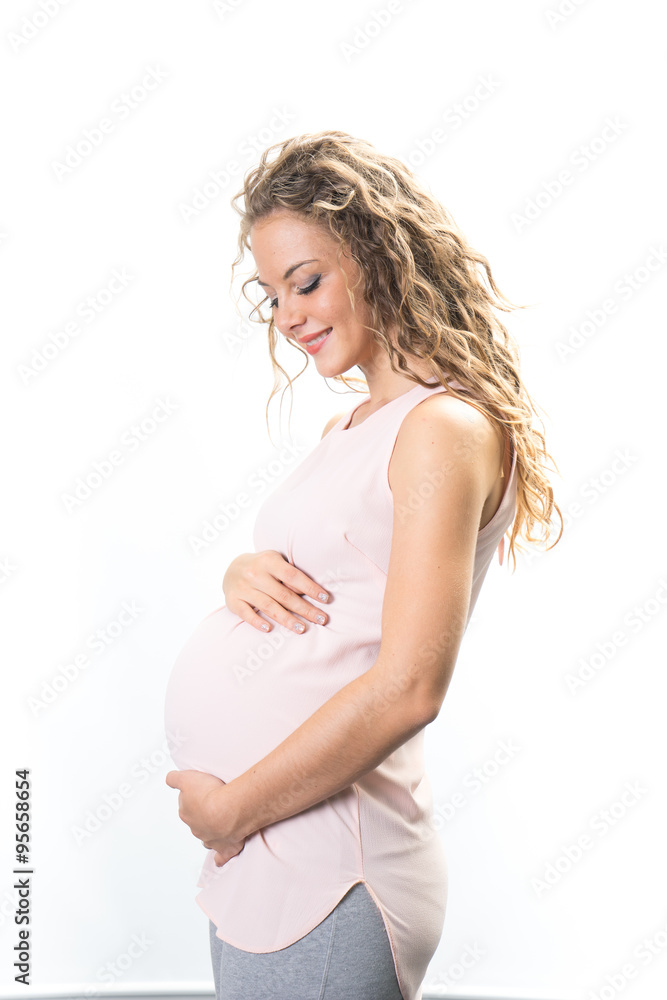 Happy and young pregnant couple in studio, white background Happy and young pregnant couple in studio, white background