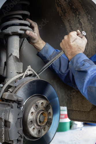 mechanic fixes brakes