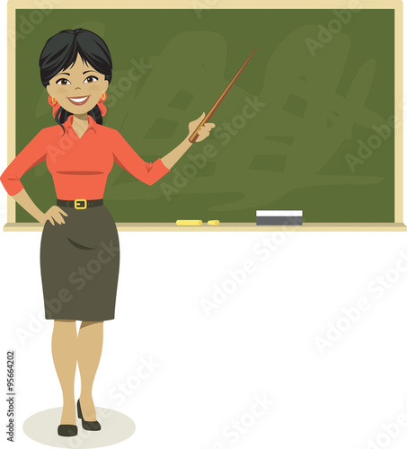 Smiling teacher holding pointer in front of blackboard