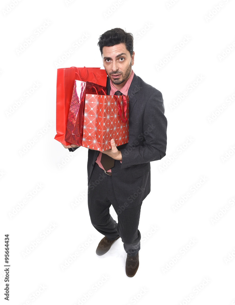 young attractive business man in stress holding lot of shopping bags and help sign looking tired bored and worried young attractive business man in stress holding lot of shopping bags and help sign looking tired bored and worried