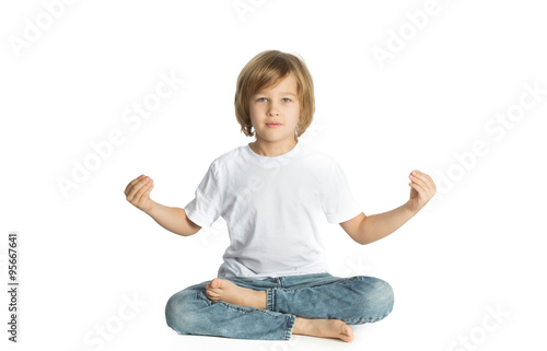Boy sitting. Yoga. Lotus Position.
