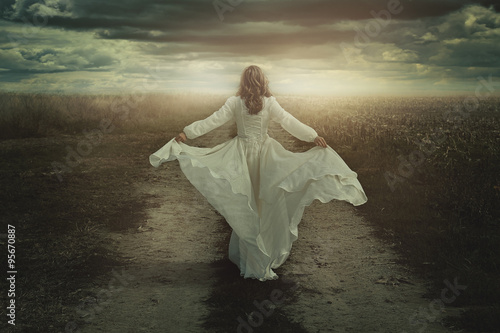 Canvas Print Woman running free in a desolate land