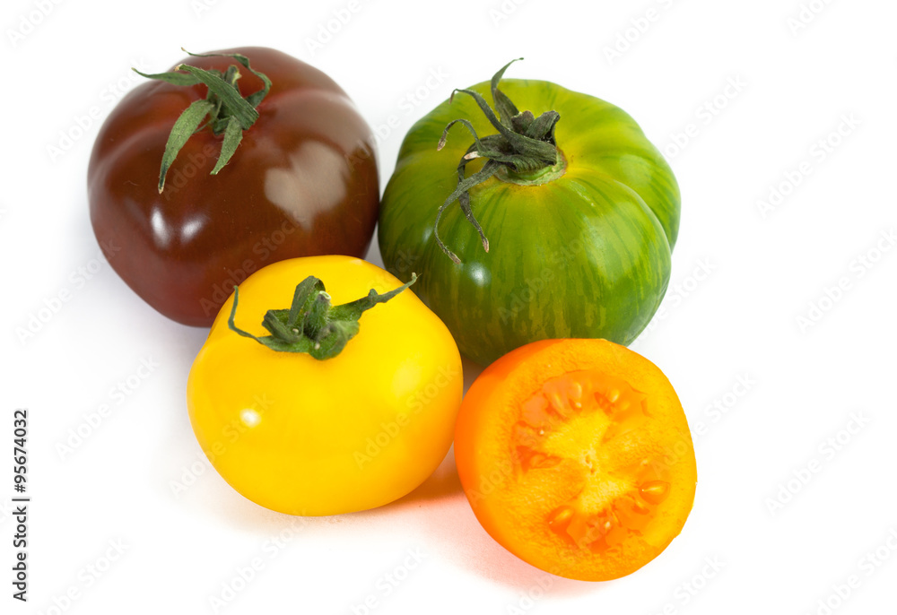 Different colors tomatos, Solanum lycopersicum, on white backgroung Different colors tomatos, Solanum lycopersicum, on white backgroung