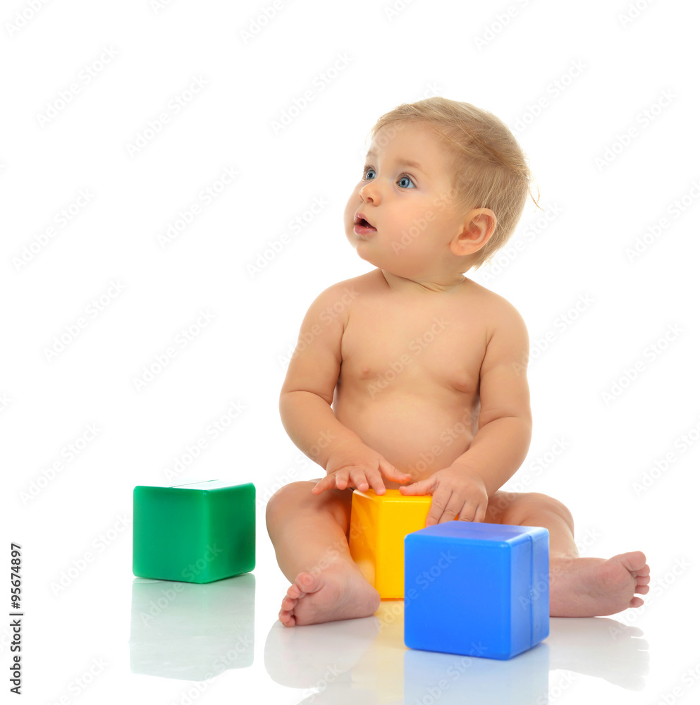 Infant child baby boy toddler playing holding green blue yellow Infant child baby boy toddler playing holding green blue yellow