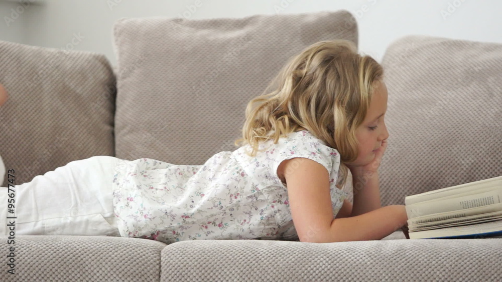 Girl lying on the couch and read a good book