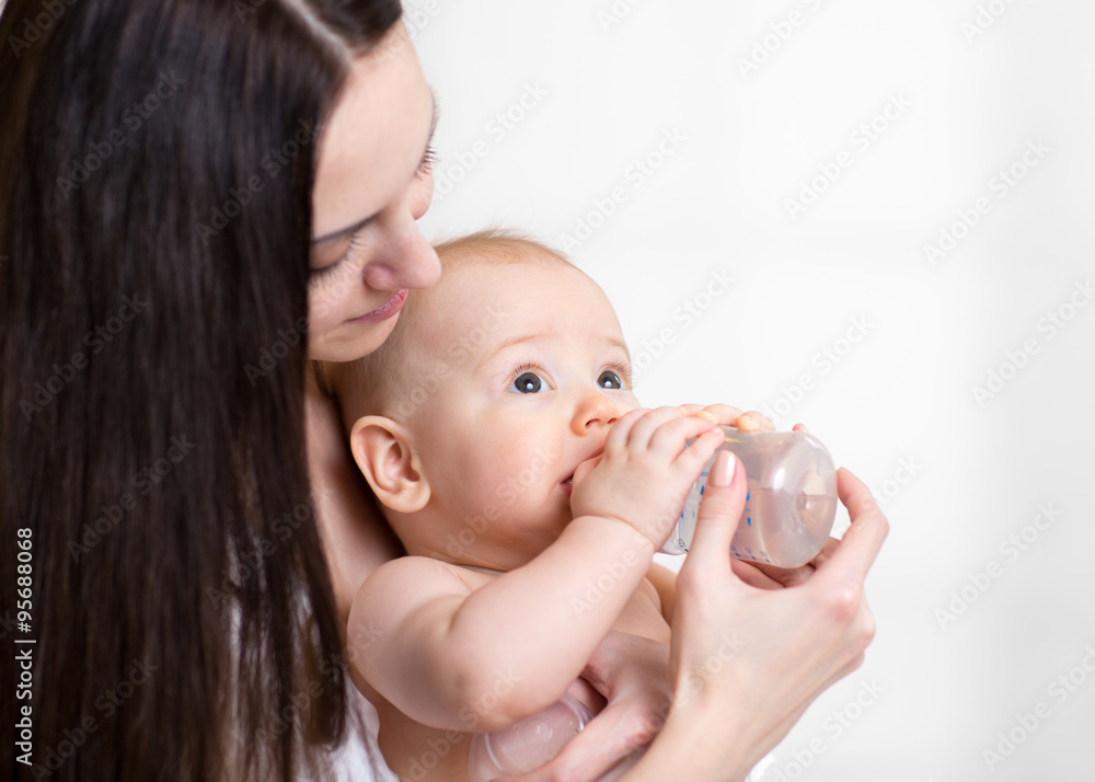 young mother feeding her adorable baby young mother feeding her adorable baby