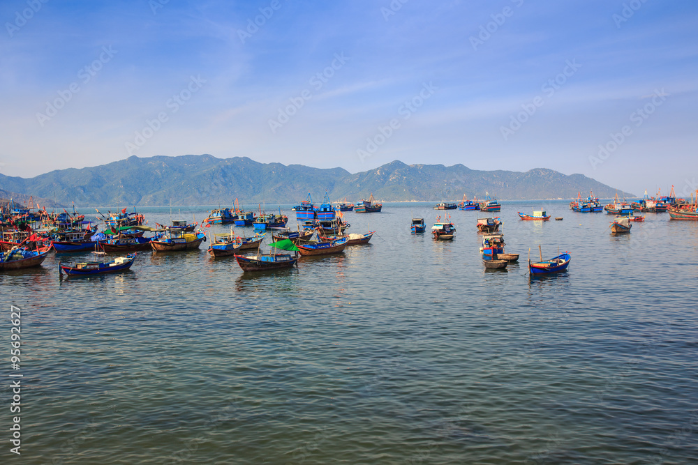 large group of Vietnamese fishing boats in azure sea large group of Vietnamese fishing boats in azure sea