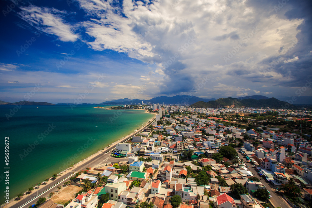 Fototapeta premium upper view of resort city near azure sea with long beach highway