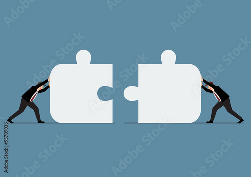 Businessmen pushing two jigsaw pieces together