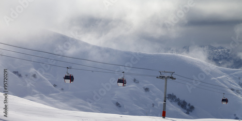 Panoramic view on gondola lifts and off-piste slope in mist