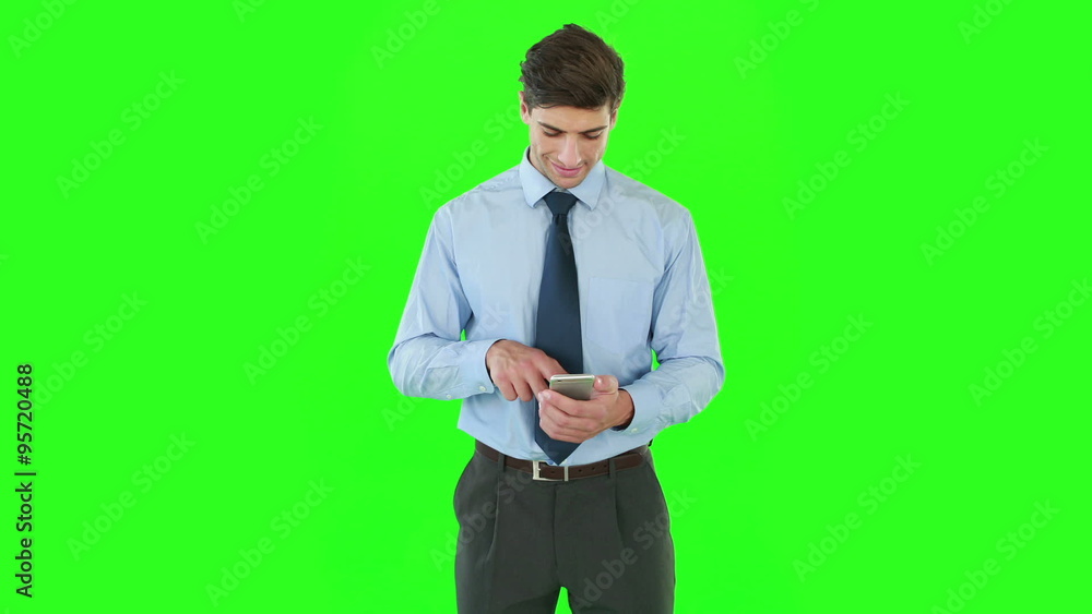 Businessman standing and using a smartphone Businessman standing and using a smartphone