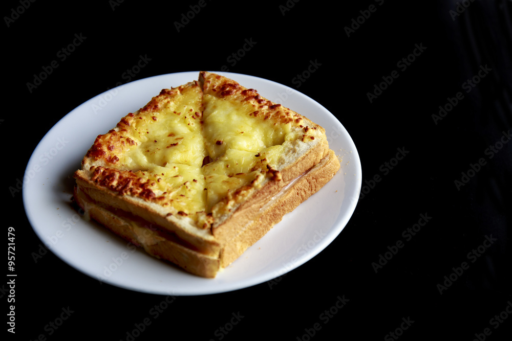 Baked cheese bread in dish.