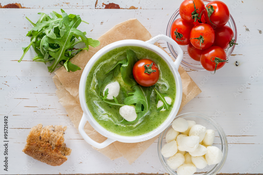 Arugula and tomatoes puree soup in white bowl Arugula and tomatoes puree soup in white bowl