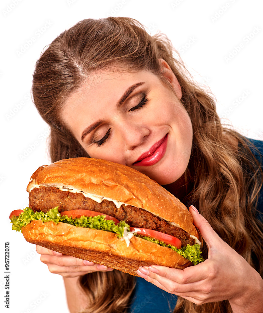 Girl eating big sandwich. Isolated.
