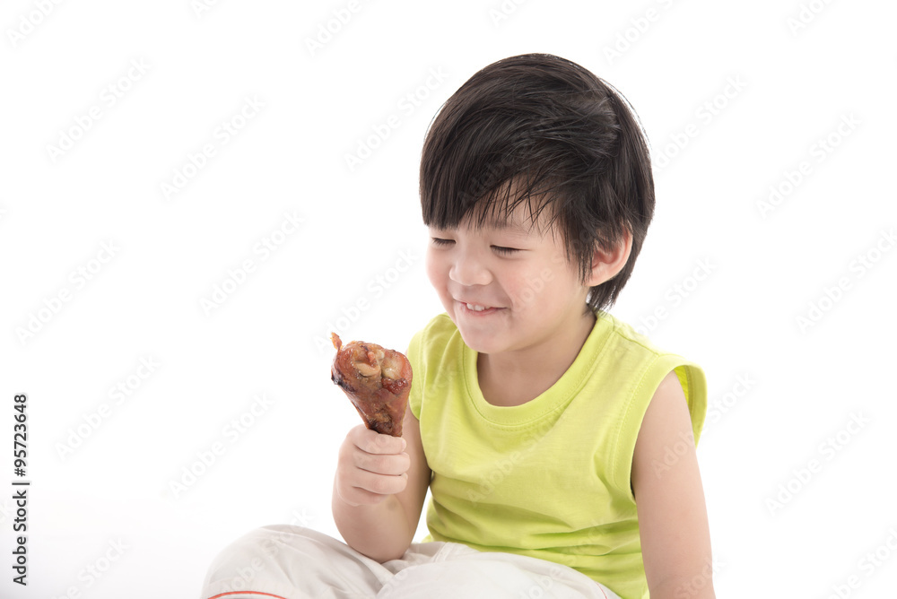Cute asian boyeating roasted chicken Cute asian boyeating roasted chicken