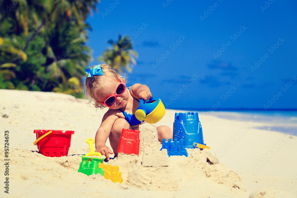 cute little girl playing with sand on beach cute little girl playing with sand on beach