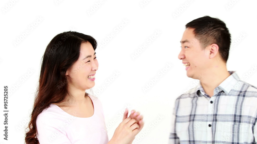 Happy couple telling secrets to each other Happy couple telling secrets to each other