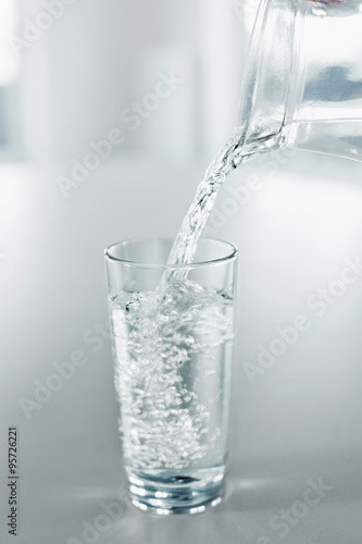 Drinking Water. Pour Water From Pitcher Into A Glass. Health, Diet, Hydratation Concept.