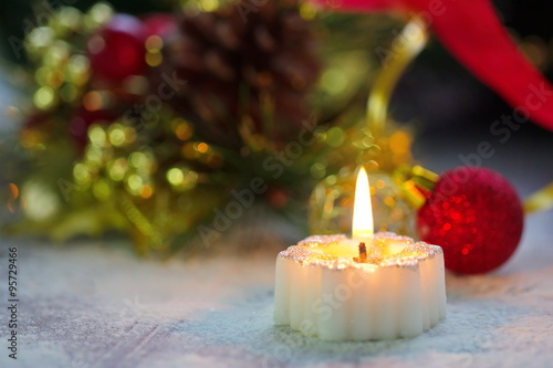 Burning candle with christmas decoration