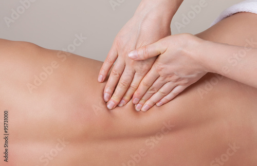 Professional therapist working on the lower back muscle