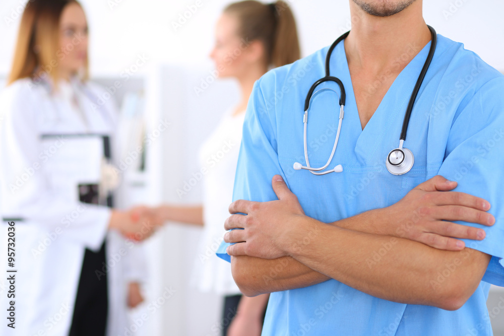 Unknown male surgeon doctor with stethoscope, crossed arms Unknown male surgeon doctor with stethoscope, crossed arms