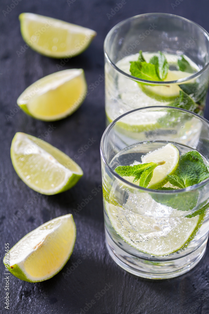 Fototapeta premium Mojito and ingredients, dark stone background