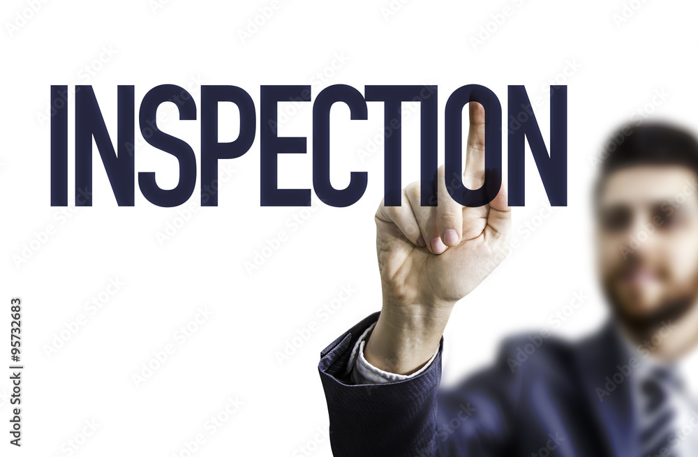 Business man pointing the text: Inspection