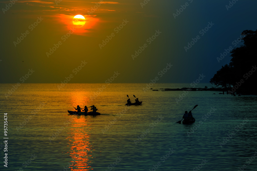 Tourists kayaking on tropical island
