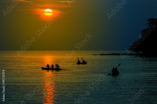 Tourists kayaking on tropical island