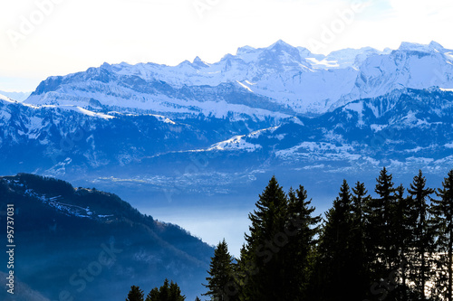 Panoramic skyline view of snow-capped mountains over lake Lucern