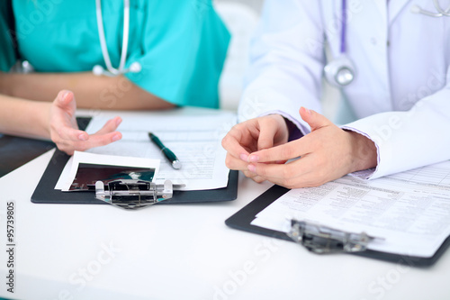 Female doctor and young surgeon intern in hospital