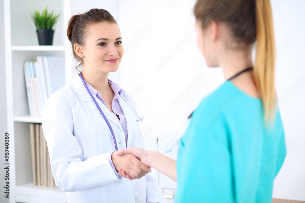 Female doctor and young surgeon intern in hospital Female doctor and young surgeon intern in hospital