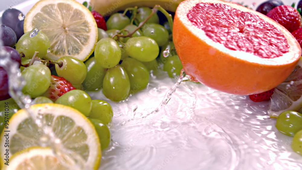 Half of a grapefruit falling into water