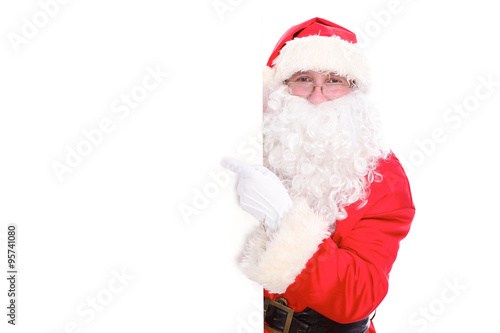 Kind Santa Claus pointing in white blank sign, isolated on white background © rogerphoto