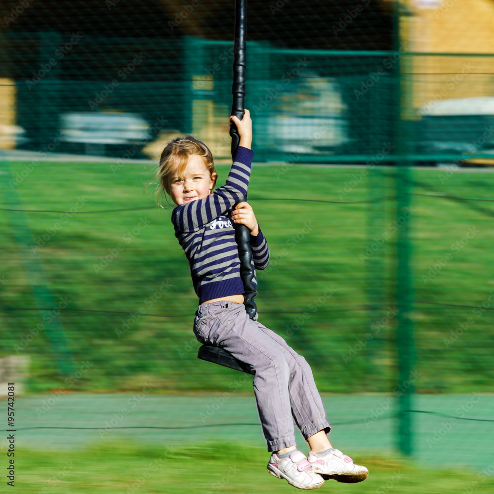 Cute girl playing on the playground, sunny day Cute girl playing on the playground, sunny day