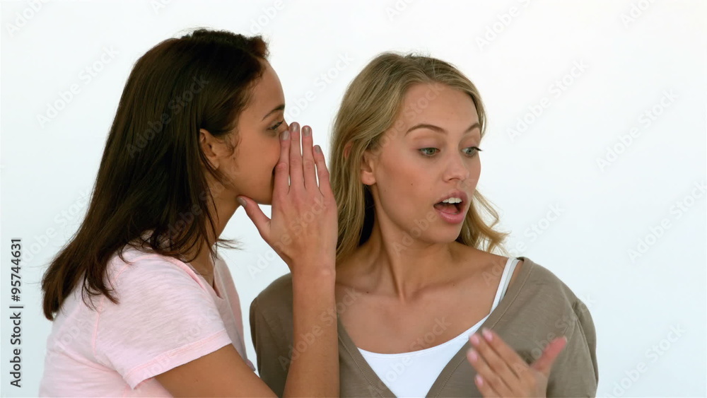 Pretty girl telling a secret to another girl Pretty girl telling a secret to another girl