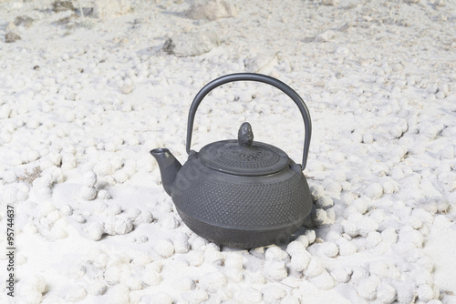 japanese teapot on sand photo