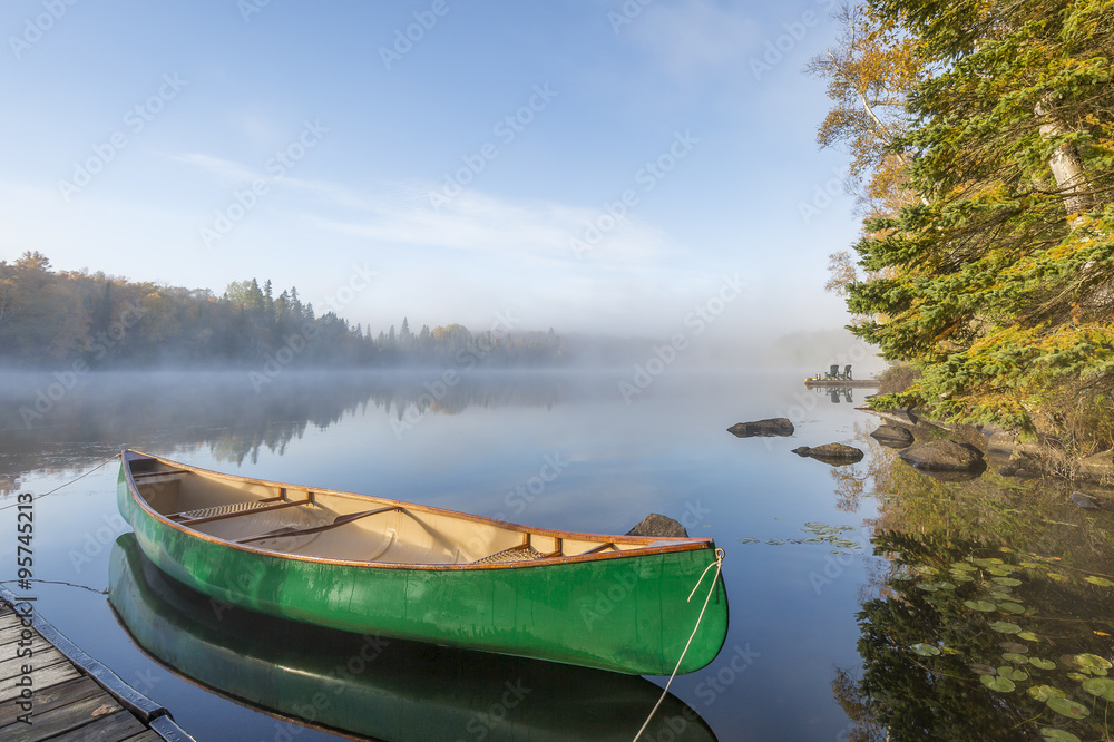 Fototapeta premium Green Canoe Tied to Dock