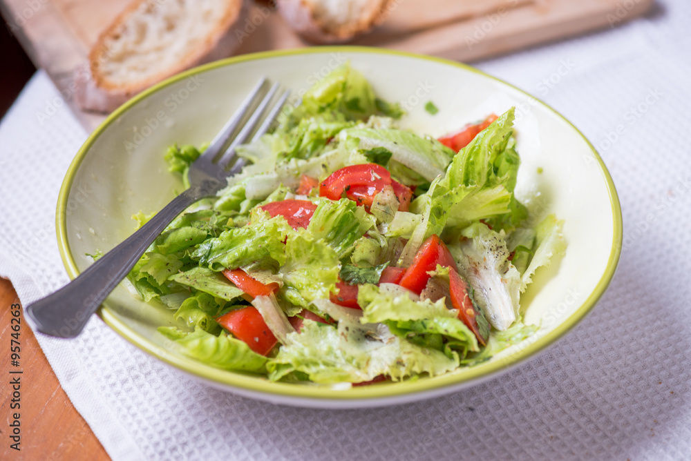 salad with lettuce leaves, cucumber and tomatoes