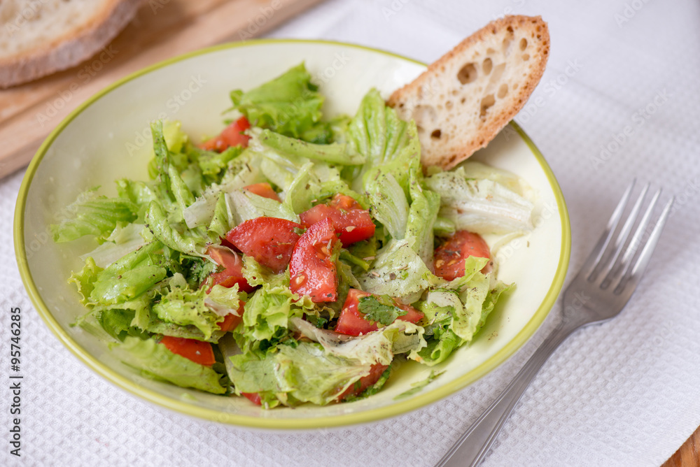 salad with lettuce leaves, cucumber and tomatoes salad with lettuce leaves, cucumber and tomatoes