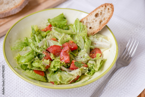 salad with lettuce leaves, cucumber and tomatoes