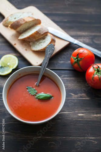 tomato soup and chopped bread on board