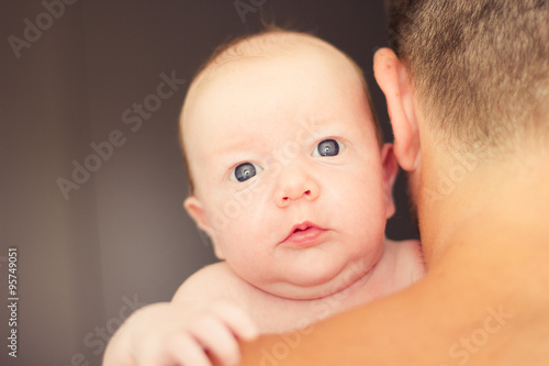 Father holding newborn baby.