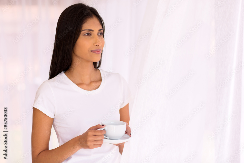 young indian woman holding coffee cup young indian woman holding coffee cup