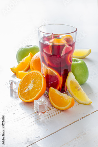 Sangria and ingredients on white wood background