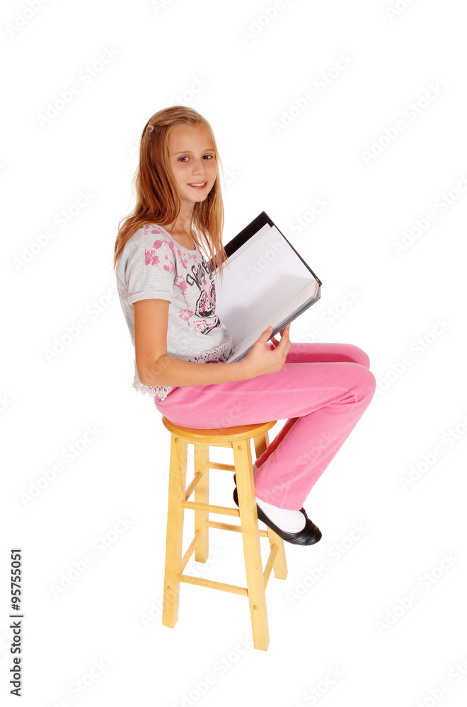 Schoolgirl sitting with her schoolbook. Schoolgirl sitting with her schoolbook.