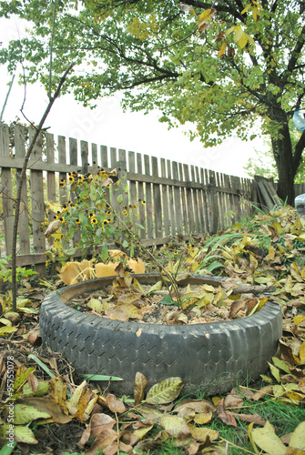 sandbox in the wheel with fallen leaves photo